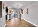 Dining area featuring hardwood floors, a modern chandelier, and access to the patio at 5442 S Cedar St, Littleton, CO 80120