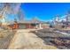 View of the home's exterior, including a covered carport and a low maintenance yard at 5442 S Cedar St, Littleton, CO 80120