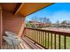 Outdoor balcony featuring seating, privacy, and a view of the community tennis court at 540 S Forest St # 5-204, Denver, CO 80246