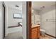 Bathroom with wood vanity, mirror, medicine cabinet, and toilet at 540 S Forest St # 5-204, Denver, CO 80246