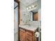 A bathroom vanity with a mirror and decorative lighting fixture at 540 S Forest St # 5-204, Denver, CO 80246