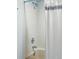 Bathroom shower and tub featuring tile surround and neutral fixtures at 540 S Forest St # 5-204, Denver, CO 80246