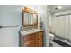 Bright bathroom with a vanity, mirror, and a shower-tub combination at 540 S Forest St # 5-204, Denver, CO 80246