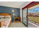 Bedroom with private balcony access and a view of the outdoors and natural light at 540 S Forest St # 5-204, Denver, CO 80246