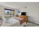 Comfortable bedroom with a sliding glass door to balcony, TV, and natural light at 540 S Forest St # 5-204, Denver, CO 80246