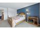 Cozy bedroom with a queen-sized bed, lamp, and a calming blue accent wall at 540 S Forest St # 5-204, Denver, CO 80246
