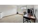 Bright bedroom featuring neutral carpet, large window with blinds, and a modern desk setup at 540 S Forest St # 5-204, Denver, CO 80246