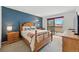 Bedroom featuring a queen-sized bed, balcony access, and ample natural light at 540 S Forest St # 5-204, Denver, CO 80246