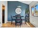 Cozy dining area features a dark wood table, seating for four, and bright natural light from the window at 540 S Forest St # 5-204, Denver, CO 80246