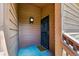 Exterior front door entryway with wood siding, black security door, and unit number at 540 S Forest St # 5-204, Denver, CO 80246