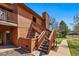 Exterior showcasing a wooden staircase leading to the entrance with mature landscaping and a sidewalk at 540 S Forest St # 5-204, Denver, CO 80246