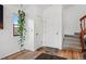 Bright foyer with hardwood floors, a closet, and a staircase leading to the upper level of the home at 540 S Forest St # 5-204, Denver, CO 80246