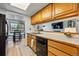 Charming kitchen with a stainless steel sink, light wood cabinetry, and seamless flow into the dining area at 540 S Forest St # 5-204, Denver, CO 80246