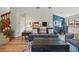 Open-concept living room with hardwood floors, access to the dining area and a staircase to the upper level at 540 S Forest St # 5-204, Denver, CO 80246