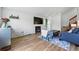 Stylish living room featuring a fireplace, modern decor, hardwood floors, and access to other areas of the home at 540 S Forest St # 5-204, Denver, CO 80246