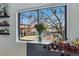 Inviting window nook featuring shelving with plants, a flower vase, and a selection of liquor at 540 S Forest St # 5-204, Denver, CO 80246