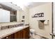 Bathroom featuring granite countertops, wooden cabinets, a shower, and decorative art at 41020 Us Highway 36, Bennett, CO 80102