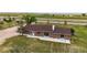 Aerial view of a charming single-Gathering home with a well-manicured yard and mature trees at 41020 Us Highway 36, Bennett, CO 80102