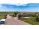 Ranch style house with a two car garage and long driveway with surrounding fields under bright blue skies at 41020 Us Highway 36, Bennett, CO 80102