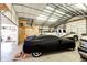 View of spacious garage featuring high ceilings and ample storage, perfect for car enthusiasts at 41020 Us Highway 36, Bennett, CO 80102