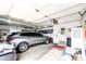 Neat garage with an SUV, built-in shelving, and organized storage against white walls at 41020 Us Highway 36, Bennett, CO 80102