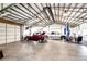 Inside the over-sized outbuilding/garage, with cars, truck, lift and table with chairs at 41020 Us Highway 36, Bennett, CO 80102