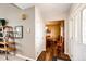Hallway view leading to the dining room, showcasing hardwood floors and a convenient coat closet at 41020 Us Highway 36, Bennett, CO 80102