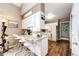 Open concept kitchen with counter seating, ample storage, and seamless flow into the dining area at 41020 Us Highway 36, Bennett, CO 80102