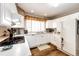 Spacious kitchen features appliances, generous counter space, and wood floors for easy meal preparation and casual dining at 41020 Us Highway 36, Bennett, CO 80102
