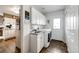 Functional laundry room equipped with a sink, cabinetry, washer, dryer, and access to the backyard at 41020 Us Highway 36, Bennett, CO 80102