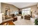 Spacious living room featuring large windows, a fireplace, vaulted ceilings, and comfortable seating at 41020 Us Highway 36, Bennett, CO 80102