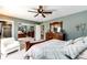 Comfortable bedroom with a ceiling fan, cozy chair, an ensuite, and a convenient mirrored closet at 41020 Us Highway 36, Bennett, CO 80102