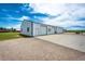 View of the extra-large outbuilding with multiple doors and ample parking at 41020 Us Highway 36, Bennett, CO 80102