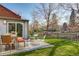 Private backyard with patio, lawn, and wooden fence at 3525 E 7Th Avenue Pkwy, Denver, CO 80206