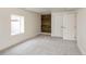 Bright basement bedroom with grey carpet, wood accent wall, and double doors at 3525 E 7Th Avenue Pkwy, Denver, CO 80206