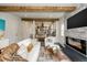 Living room with fireplace, exposed beams, and upper level view at 3525 E 7Th Avenue Pkwy, Denver, CO 80206