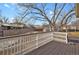 Deck overlooking a backyard with mature trees and neighborhood views at 4531 S Iris St, Littleton, CO 80123