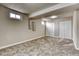 Finished basement area with large windows, carpeted floor and ample storage space at 10420 Marion St, Northglenn, CO 80233