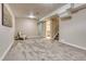 Finished basement with neutral carpet leading to a bathroom and stairs to the main floor at 10420 Marion St, Northglenn, CO 80233