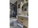 Well-lit bathroom featuring a bathtub with a marble surround, updated vanity, and decorative gold fixtures at 10420 Marion St, Northglenn, CO 80233