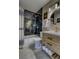 Updated bathroom showcases dark tile accents, modern light fixtures and fixtures at 10420 Marion St, Northglenn, CO 80233