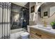 Updated bathroom features dark tile accents, sleek hardware, and modern finishes at 10420 Marion St, Northglenn, CO 80233
