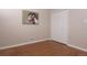 Cozy bedroom with wood-look floors and a double door closet with a decorative painting above the vent at 10420 Marion St, Northglenn, CO 80233