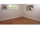 Well-lit room with hardwood floors, a window looking out onto the green trees, and neutral colored walls at 10420 Marion St, Northglenn, CO 80233