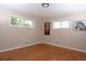 This bedroom features two windows for bright natural light and hardwood floors at 10420 Marion St, Northglenn, CO 80233