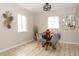 Bright dining room includes a modern light fixture and large windows at 10420 Marion St, Northglenn, CO 80233