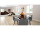 An open floor plan is showcased in this dining room adjacent to the living room at 10420 Marion St, Northglenn, CO 80233