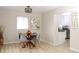 Bright dining room features a modern light fixture and views into the updated kitchen at 10420 Marion St, Northglenn, CO 80233