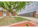 Front yard with mature tree, mulch bed and brick home exterior at 10420 Marion St, Northglenn, CO 80233