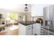 Modern kitchen with white cabinets, granite countertops and stainless steel refrigerator at 10420 Marion St, Northglenn, CO 80233